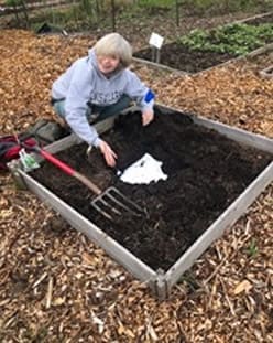 Woman burying undies in her garden