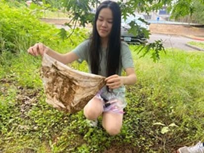 Young woman looking at undies that were buried for 2 months.